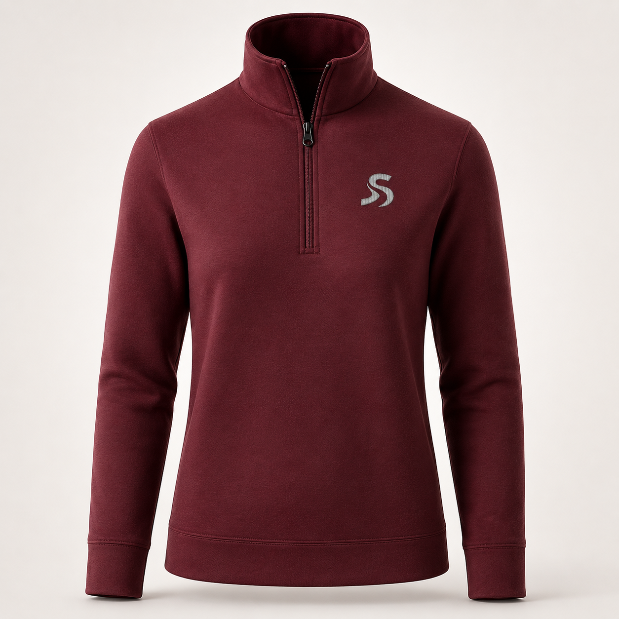 A women's maroon half-zip pullover sweater with a stand-up collar and a small silver embroidered 'S' logo on the left chest, shown against a light gray studio background. Perfect mid layer for skiing.