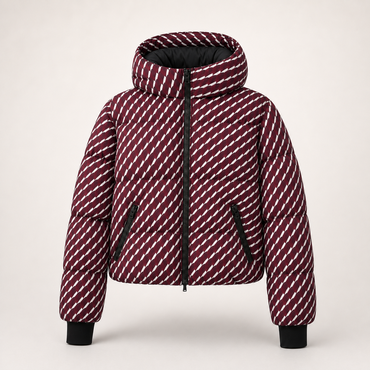 A hooded puffer ski jacket with a diagonal striped pattern in burgundy and white, featuring black zippers, black trim, and black ribbed cuffs, shown against a light beige background.