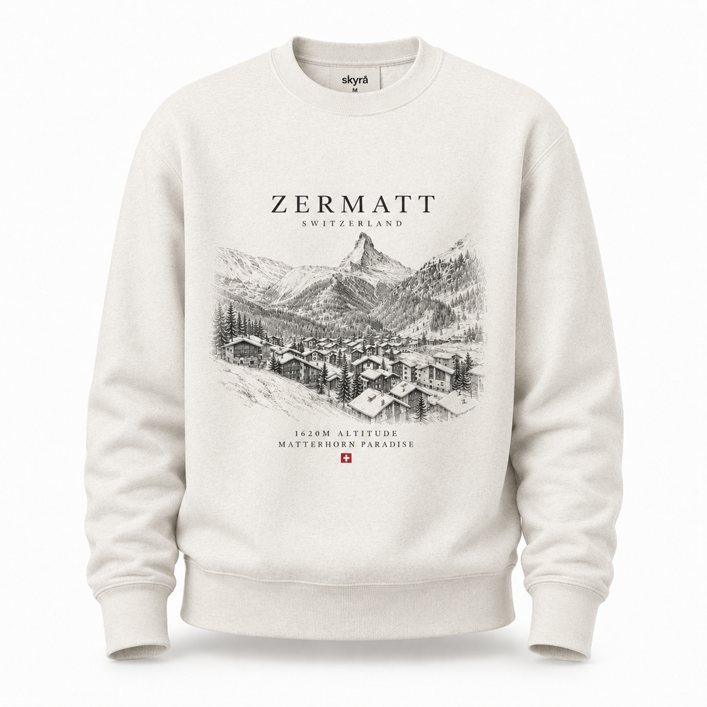 An off-white crewneck sweatshirt featuring a black line art graphic of Zermatt, Switzerland, with the text 'ZERMATT SWITZERLAND' and 'Matterhorn Paradise' printed on the front